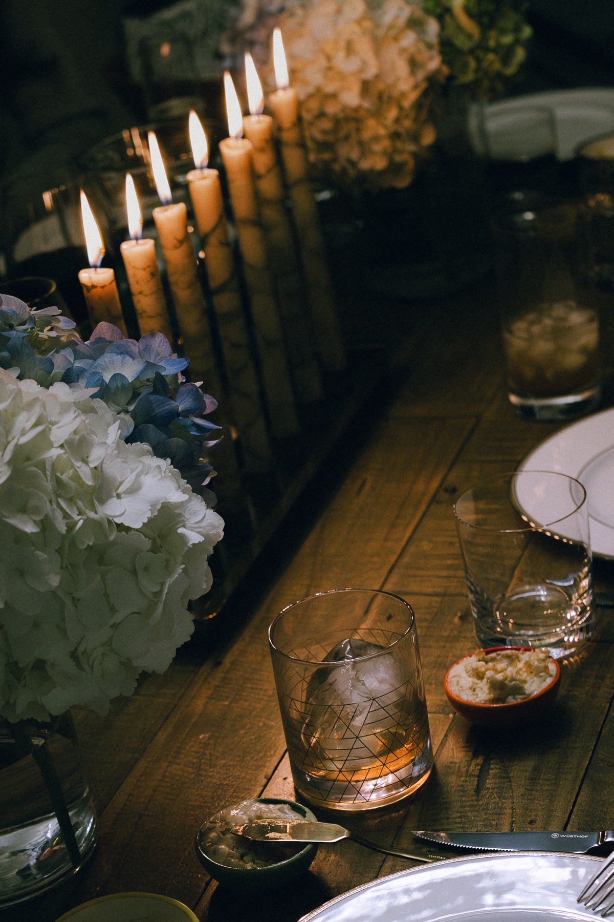 Candlelit table with cocktails and hydrangeas